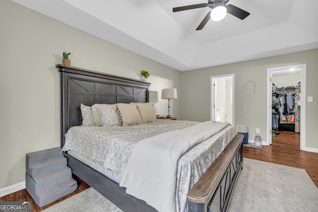 131 Glenn Fuller Cir, Commerce, GA 30529 - bedroom featuring a raised ceiling, wood finished floors, a spacious closet, baseboards, and a closet