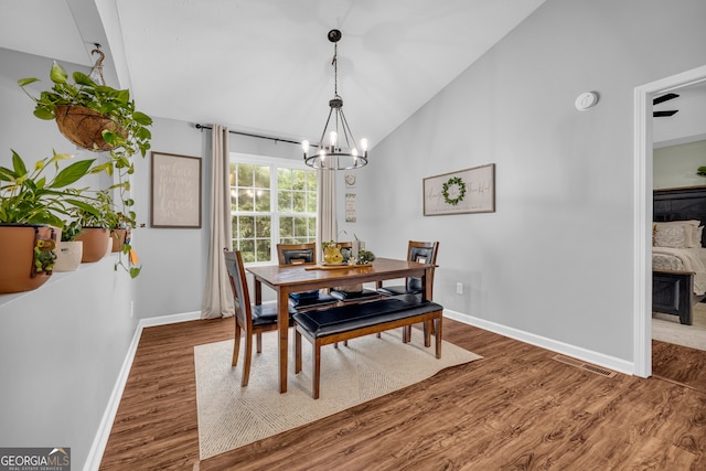 131 Glenn Fuller Cir, Commerce, GA 30529 - dining area featuring vaulted ceiling, wood finished floors, a chandelier, and baseboards