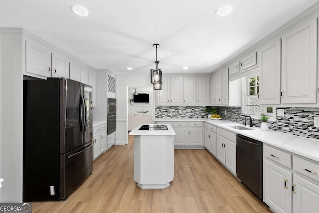 5706 Brookstone Walk NW, Acworth, GA 30101 - kitchen featuring black appliances, recessed lighting, decorative backsplash, a center island, and light countertops