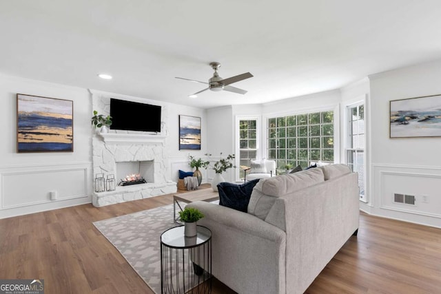 5706 Brookstone Walk NW, Acworth, GA 30101 - living area featuring ceiling fan, a fireplace, wood finished floors, a decorative wall, and recessed lighting