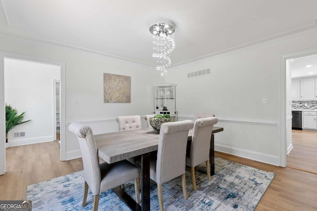 5706 Brookstone Walk NW, Acworth, GA 30101 - dining area featuring light wood-style floors, crown molding, and a chandelier
