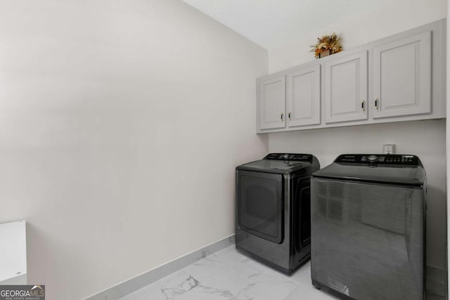 5706 Brookstone Walk NW, Acworth, GA 30101 - laundry room featuring cabinet space, washer and clothes dryer, and light marble finish flooring