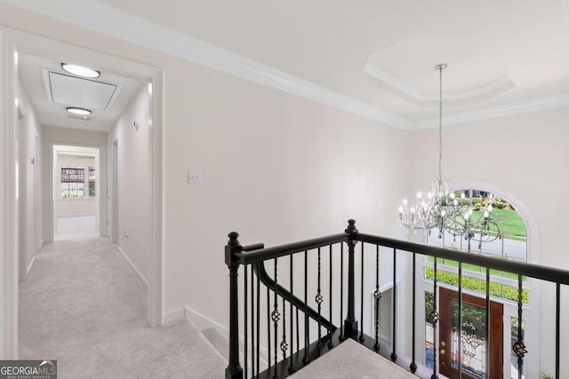 5706 Brookstone Walk NW, Acworth, GA 30101 - hall featuring an upstairs landing, carpet floors, attic access, a chandelier, and a raised ceiling