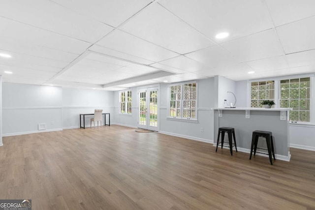 5706 Brookstone Walk NW, Acworth, GA 30101 - unfurnished living room with wood finished floors, healthy amount of natural light, and a drop ceiling