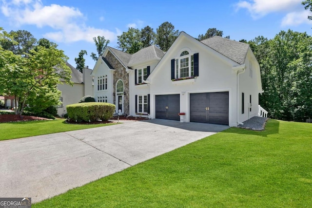 5706 Brookstone Walk NW, Acworth, GA 30101 - view of front facade with a garage, concrete driveway, a front lawn, stucco siding, and a shingled roof