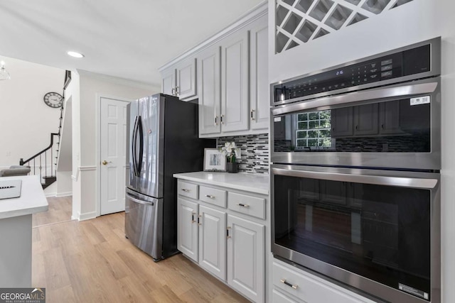 5706 Brookstone Walk NW, Acworth, GA 30101 - kitchen with appliances with stainless steel finishes, light wood-style floors, tasteful backsplash, light countertops, and recessed lighting