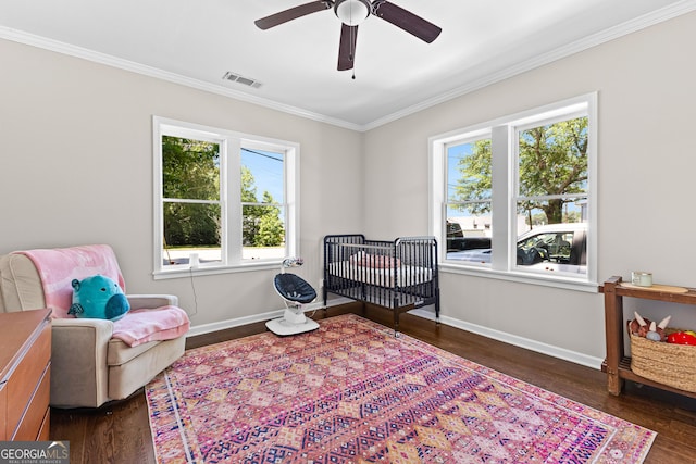 73 Fair St, Newnan, GA 30263 - bedroom featuring baseboards, ornamental molding, dark wood-type flooring, a crib, and ceiling fan