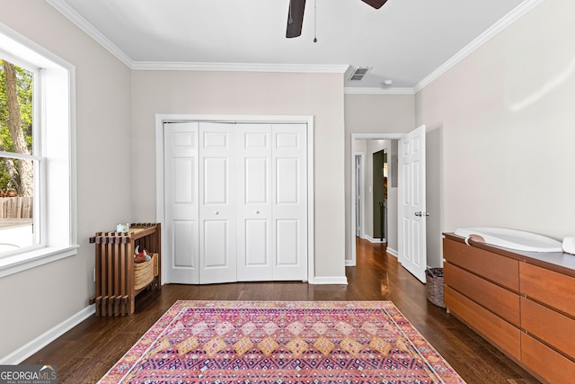 73 Fair St, Newnan, GA 30263 - bedroom featuring dark wood-style floors, crown molding, a closet, baseboards, and a ceiling fan