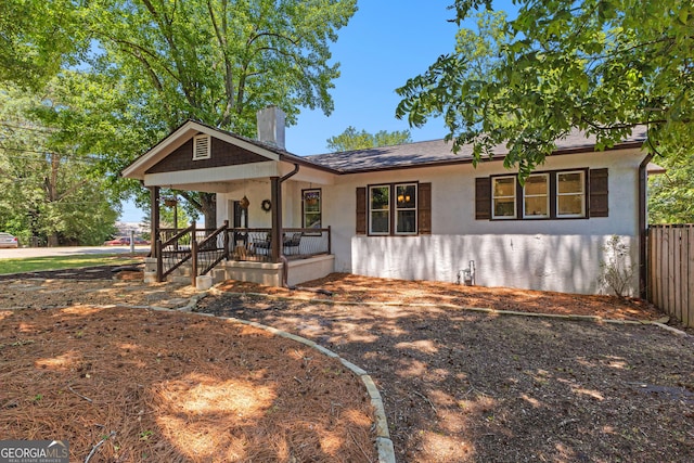 73 Fair St, Newnan, GA 30263 - ranch-style home with a porch, a chimney, and stucco siding