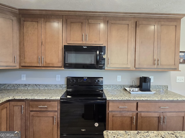 1356 Woodbrier, Sautee Nacoochee, GA 30571 - kitchen with black appliances, brown cabinets, and light stone counters