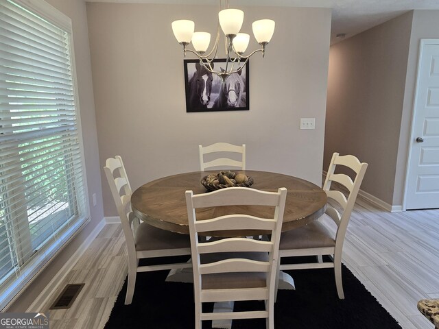 1356 Woodbrier, Sautee Nacoochee, GA 30571 - dining area featuring a chandelier, light wood-type flooring, and baseboards