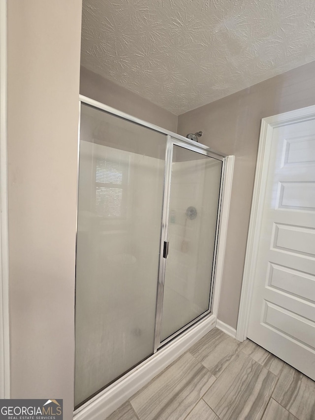 1356 Woodbrier, Sautee Nacoochee, GA 30571 - bathroom with a stall shower and a textured ceiling