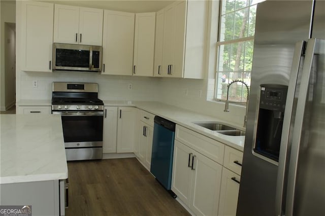 4220 Glad Morning Dr, College Park, GA 30349 - kitchen with appliances with stainless steel finishes, a sink, tasteful backsplash, and white cabinetry
