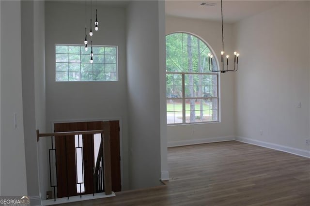4220 Glad Morning Dr, College Park, GA 30349 - foyer entrance with a chandelier, plenty of natural light, wood finished floors, and baseboards