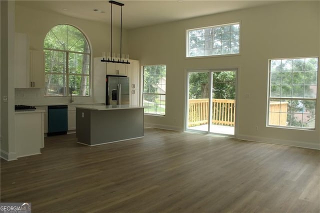 4220 Glad Morning Dr, College Park, GA 30349 - unfurnished living room featuring dark wood-style flooring, a towering ceiling, a sink, and baseboards