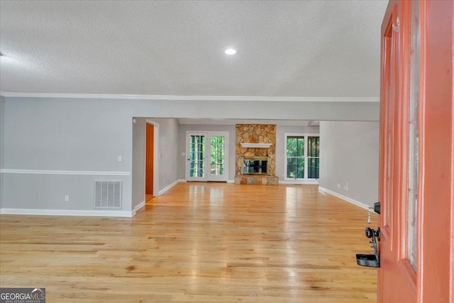 112 White Oak Cir, Dublin, GA 31021 - unfurnished living room with a textured ceiling, wood finished floors, crown molding, baseboards, and a fireplace