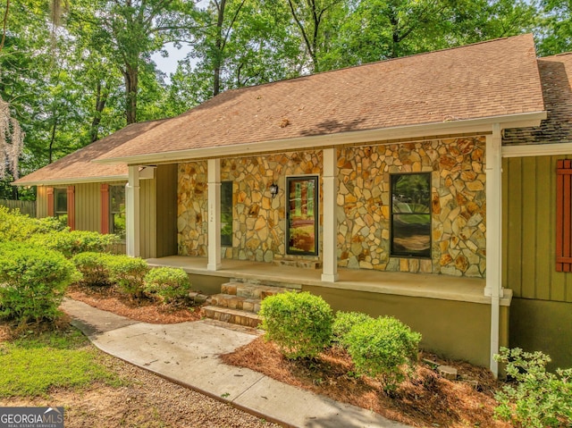 112 White Oak Cir, Dublin, GA 31021 - view of front of property with a shingled roof, covered porch, stone siding, and board and batten siding