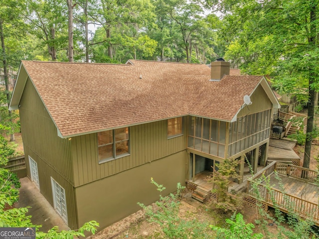 112 White Oak Cir, Dublin, GA 31021 - back of house with roof with shingles, a deck, a chimney, and a sunroom