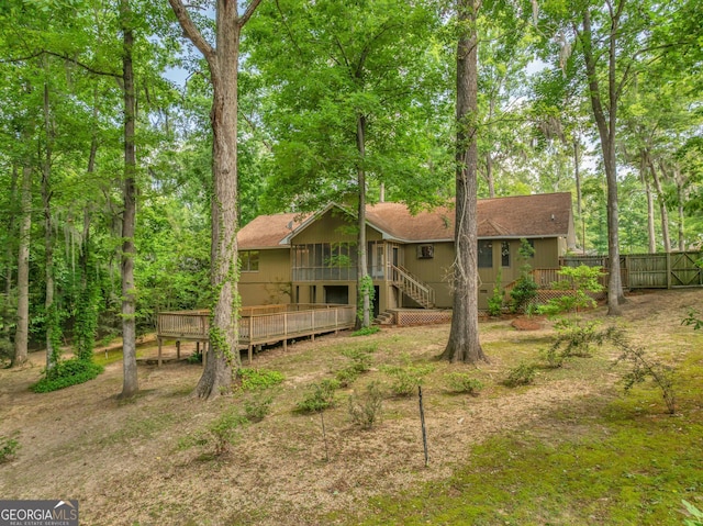 112 White Oak Cir, Dublin, GA 31021 - rear view of property featuring a sunroom, a deck, stairway, and roof with shingles