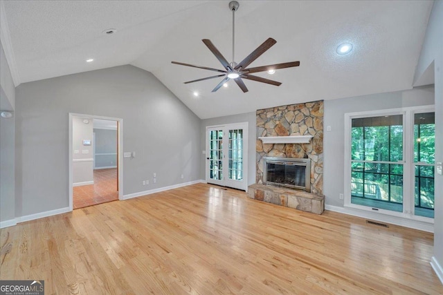 112 White Oak Cir, Dublin, GA 31021 - unfurnished living room featuring ceiling fan, wood finished floors, lofted ceiling, healthy amount of natural light, and a fireplace