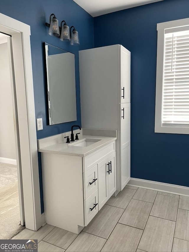 15785 Concord St, Zebulon, GA 30295 - bathroom featuring vanity, baseboards, and wood finish floors
