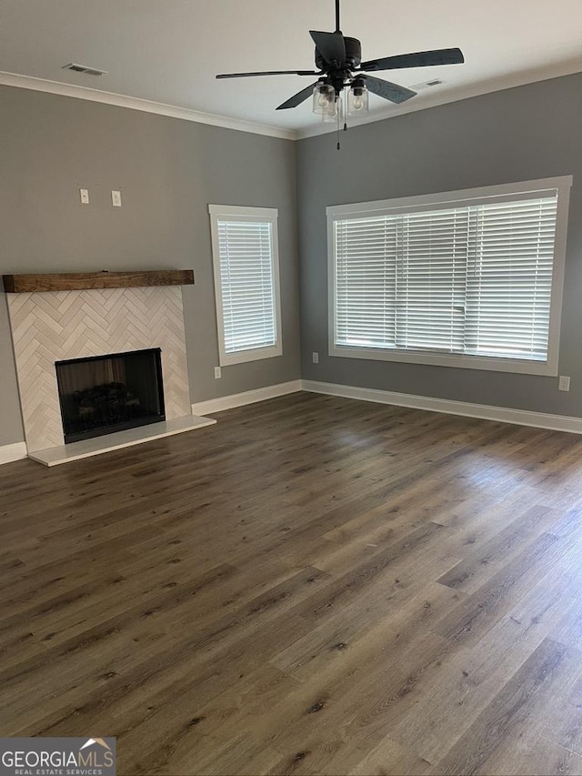 15785 Concord St, Zebulon, GA 30295 - unfurnished living room with crown molding, baseboards, dark wood finished floors, ceiling fan, and a fireplace
