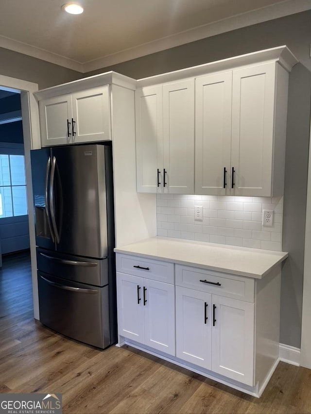 15785 Concord St, Zebulon, GA 30295 - kitchen featuring refrigerator with ice dispenser, ornamental molding, light wood-type flooring, white cabinetry, and recessed lighting