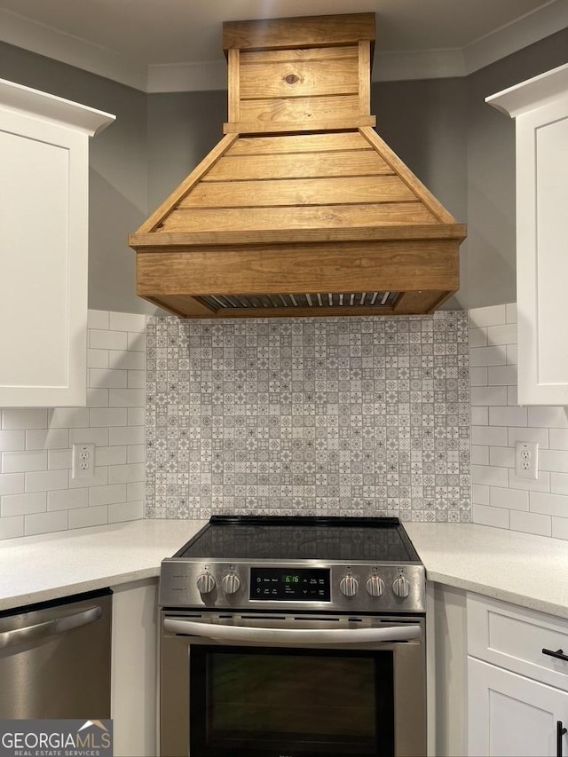 15785 Concord St, Zebulon, GA 30295 - kitchen with stainless steel appliances, premium range hood, ornamental molding, white cabinetry, and decorative backsplash