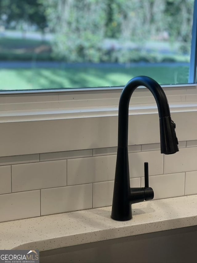 15785 Concord St, Zebulon, GA 30295 - detailed view of tasteful backsplash, a sink, and light stone countertops