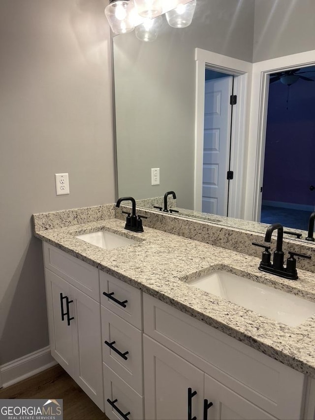15785 Concord St, Zebulon, GA 30295 - bathroom featuring double vanity, baseboards, and wood finished floors