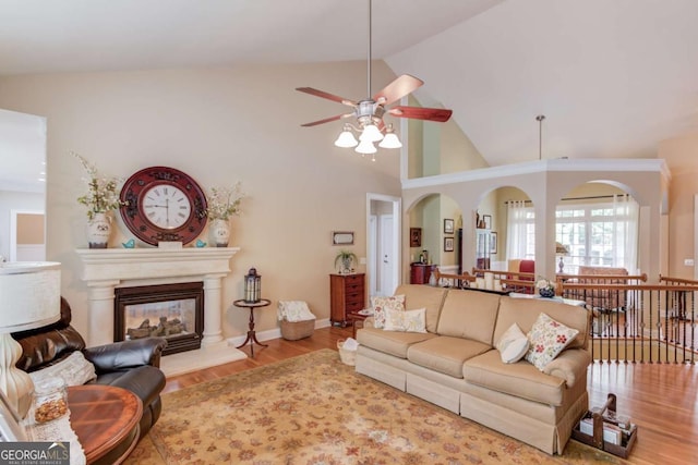 901 Providence Ln, Monroe, GA 30656 - living room featuring ceiling fan, high vaulted ceiling, wood finished floors, and a glass covered fireplace