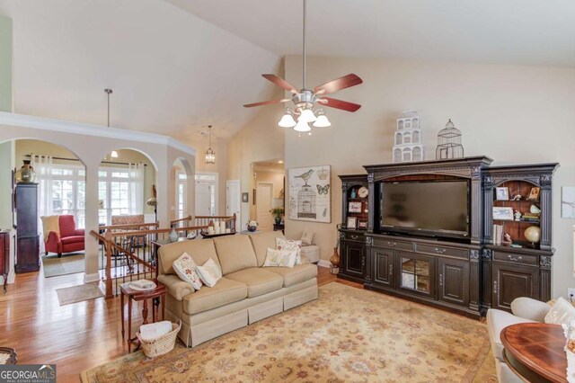 901 Providence Ln, Monroe, GA 30656 - living room featuring a ceiling fan, wood finished floors, high vaulted ceiling, arched walkways, and baseboards