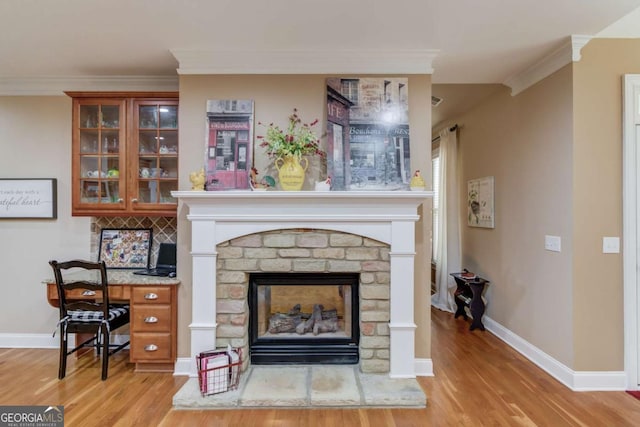 901 Providence Ln, Monroe, GA 30656 - detailed view of wood finished floors, a brick fireplace, ornamental molding, baseboards, and an office area