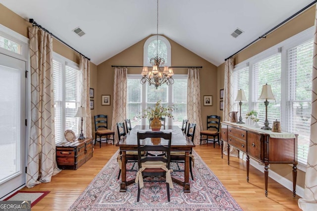 901 Providence Ln, Monroe, GA 30656 - dining room with a chandelier, light wood-type flooring, and vaulted ceiling