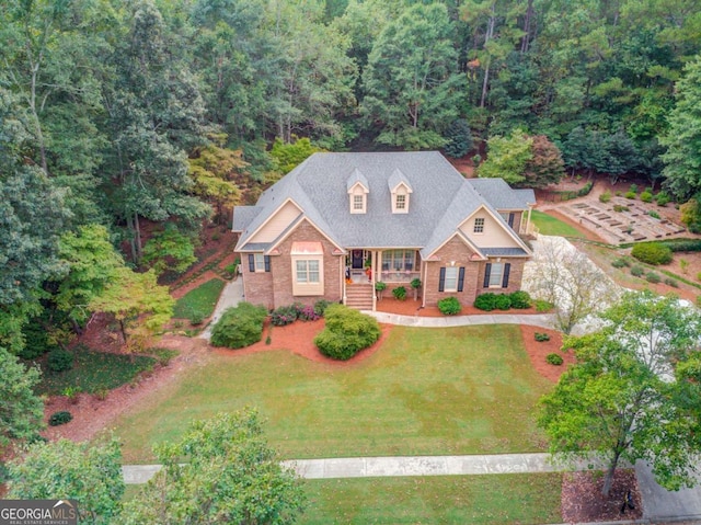 901 Providence Ln, Monroe, GA 30656 - view of front of home featuring brick siding, a porch, a view of trees, and a front lawn