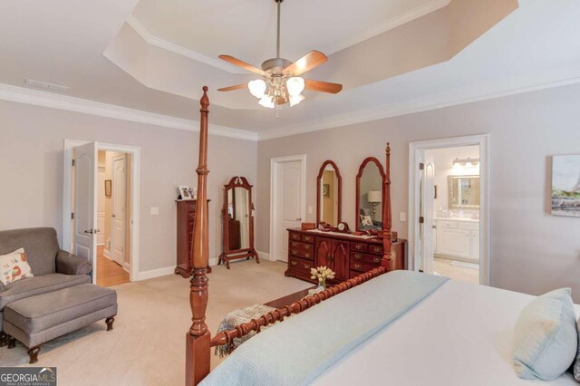 901 Providence Ln, Monroe, GA 30656 - bedroom featuring ornamental molding, a tray ceiling, light carpet, ensuite bath, and a ceiling fan