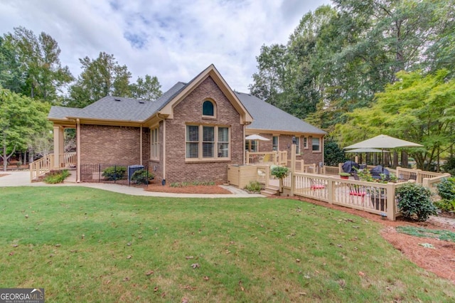 901 Providence Ln, Monroe, GA 30656 - view of front of home with brick siding, a front yard, and a deck