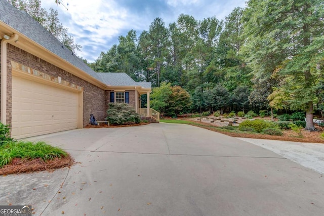 901 Providence Ln, Monroe, GA 30656 - view of front of house featuring driveway, brick siding, a shingled roof, and an attached garage