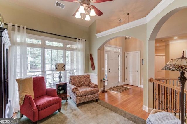 901 Providence Ln, Monroe, GA 30656 - entrance foyer featuring arched walkways, ceiling fan, wood finished floors, and ornamental molding