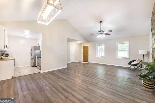 642 Chickamauga Dr, Macon, GA 31220 - unfurnished living room featuring ceiling fan, vaulted ceiling, wood finished floors, and baseboards