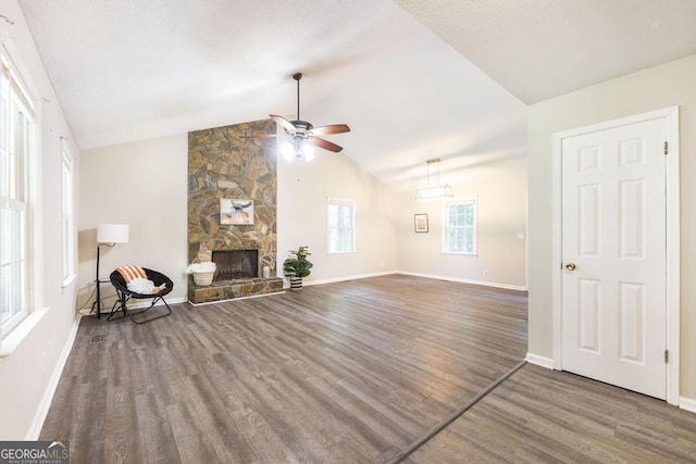 642 Chickamauga Dr, Macon, GA 31220 - unfurnished living room with a ceiling fan, wood finished floors, vaulted ceiling, baseboards, and a fireplace