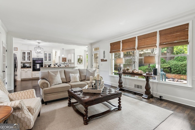 750 Highview Ct, Woodstock, GA 30189 - living area featuring crown molding, dark wood-style flooring, baseboards, and a chandelier
