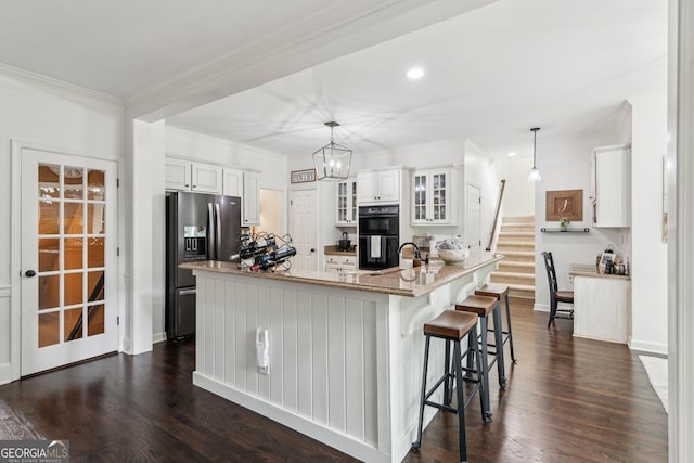 750 Highview Ct, Woodstock, GA 30189 - kitchen with stainless steel refrigerator with ice dispenser, white cabinetry, glass insert cabinets, a kitchen bar, and crown molding