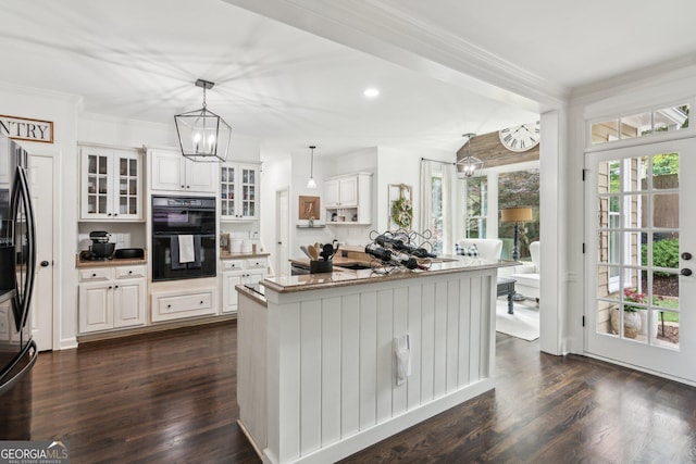 750 Highview Ct, Woodstock, GA 30189 - kitchen with a chandelier, hanging light fixtures, white cabinets, glass insert cabinets, and crown molding