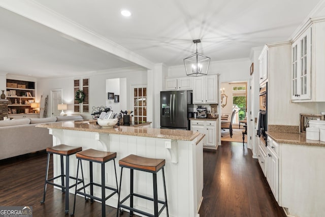 750 Highview Ct, Woodstock, GA 30189 - kitchen with black refrigerator with ice dispenser, a breakfast bar, a center island, dark wood-style flooring, and ornamental molding