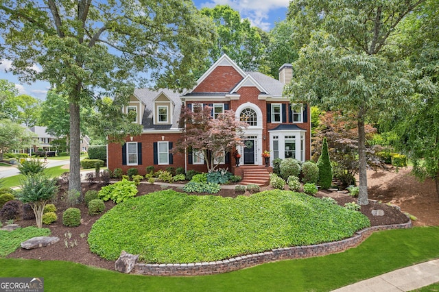 750 Highview Ct, Woodstock, GA 30189 - georgian-style home with brick siding, a front yard, and a chimney