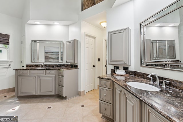 750 Highview Ct, Woodstock, GA 30189 - bathroom with two vanities, a towering ceiling, tile patterned flooring, and baseboards
