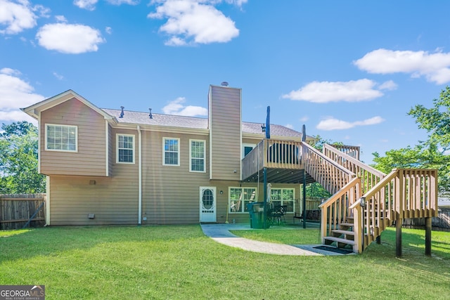 435 Flowering Trl, Grayson, GA 30017 - rear view of house with a wooden deck, stairs, a chimney, and a patio