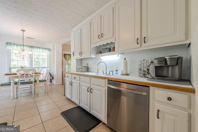435 Flowering Trl, Grayson, GA 30017 - kitchen with dishwasher, a sink, light tile patterned flooring, a textured ceiling, and a chandelier