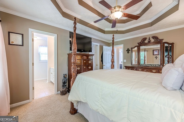 435 Flowering Trl, Grayson, GA 30017 - carpeted bedroom with a tray ceiling, crown molding, baseboards, connected bathroom, and a ceiling fan